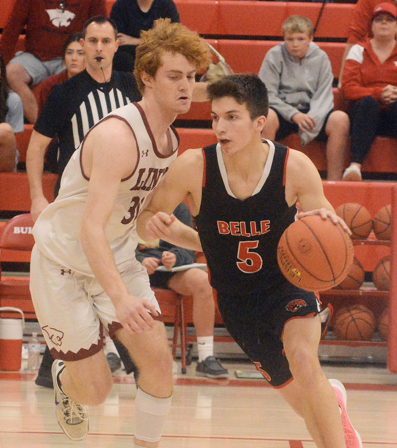 Brayden Cadwallader (far right) handles the basketball while being guarded by Linn’s Noah Hall during first-round action at the Missouri State High School Activities Association (MSHSAA) Class 3, District 9 Tournament at Dixon High School.
